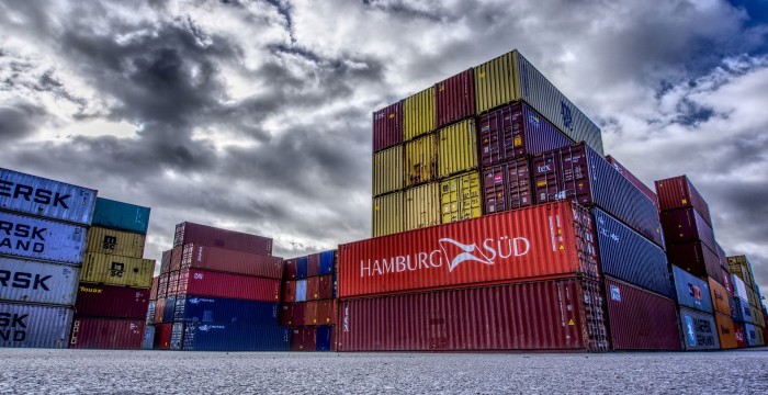 shipping containers against dramatic sky