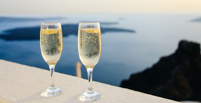 two glasses of champagne overlooking sea in distance