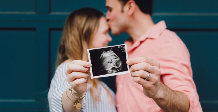couple holding ultrasound image