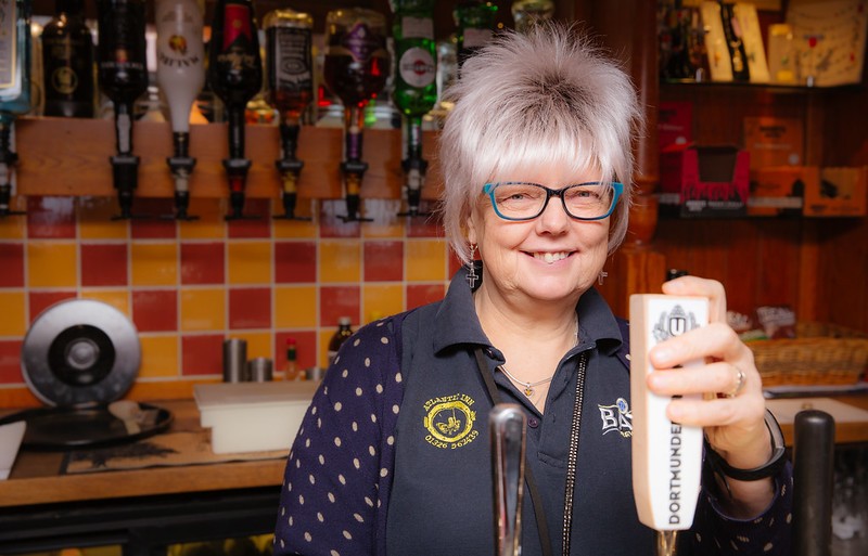 Leigh Santi standing behind the bar at the Atlantic Inn pub