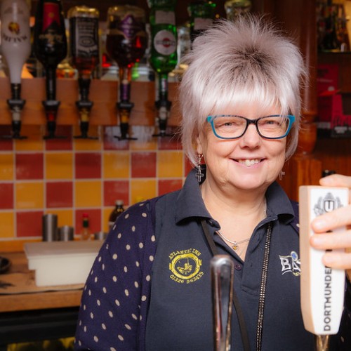 Leigh Santi standing behind the bar at the Atlantic Inn pub